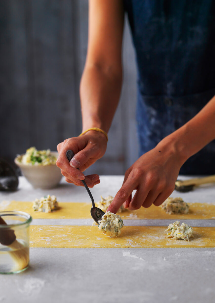 young-woman-filling-pasta-fresh-marble
